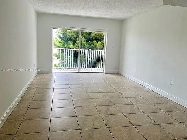 4810 Northwest 79th Avenue, Unit 305 Doral, FL 33166 - Photo 2 of 28 a view of a livingroom with an empty space and a window