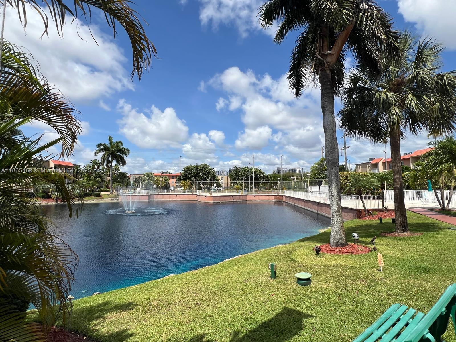 4810 Northwest 79th Avenue, Unit 305 Doral, FL 33166 - Photo 27 of 28 a view of a lake with a yard