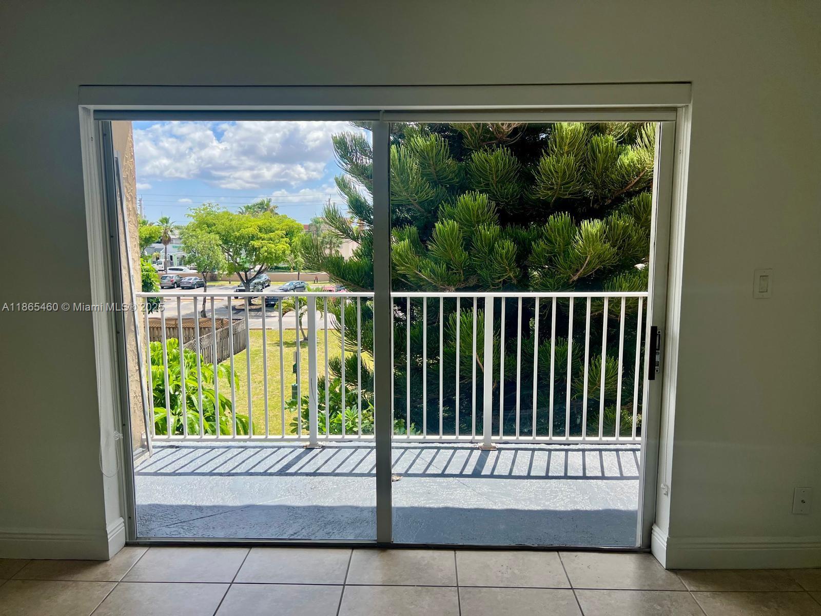 4810 Northwest 79th Avenue, Unit 305 Doral, FL 33166 - Photo 3 of 28 a view of a porch with a small yard
