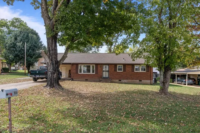 a house that has tree in front of it