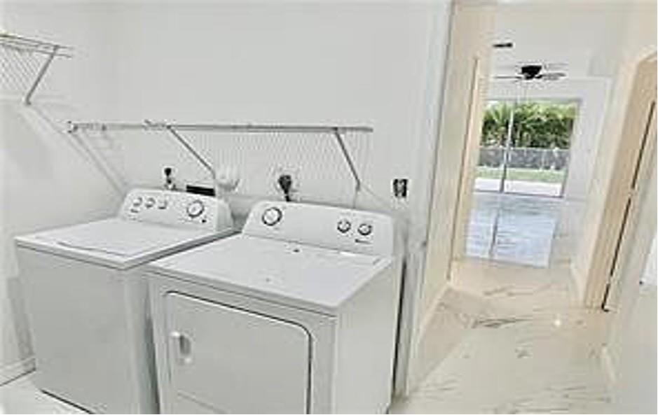 11041 Harbour Springs Circle Boca Raton, FL 33428 - Photo 14 of 15 a utility room with dryer and washer