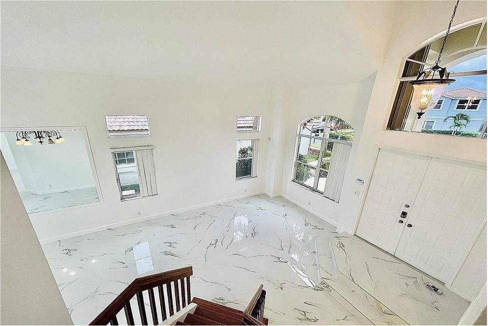 11041 Harbour Springs Circle Boca Raton, FL 33428 - Photo 6 of 15 a view of a bedroom with baby crib and wooden floor