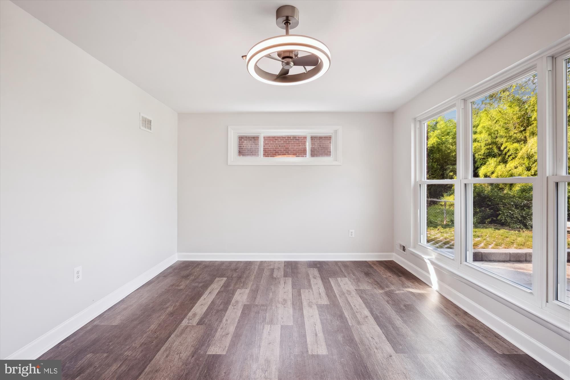 12812 Crisfield Road Silver Spring, MD 20906 - Photo 11 of 83 a view of empty room with wooden floor and fan