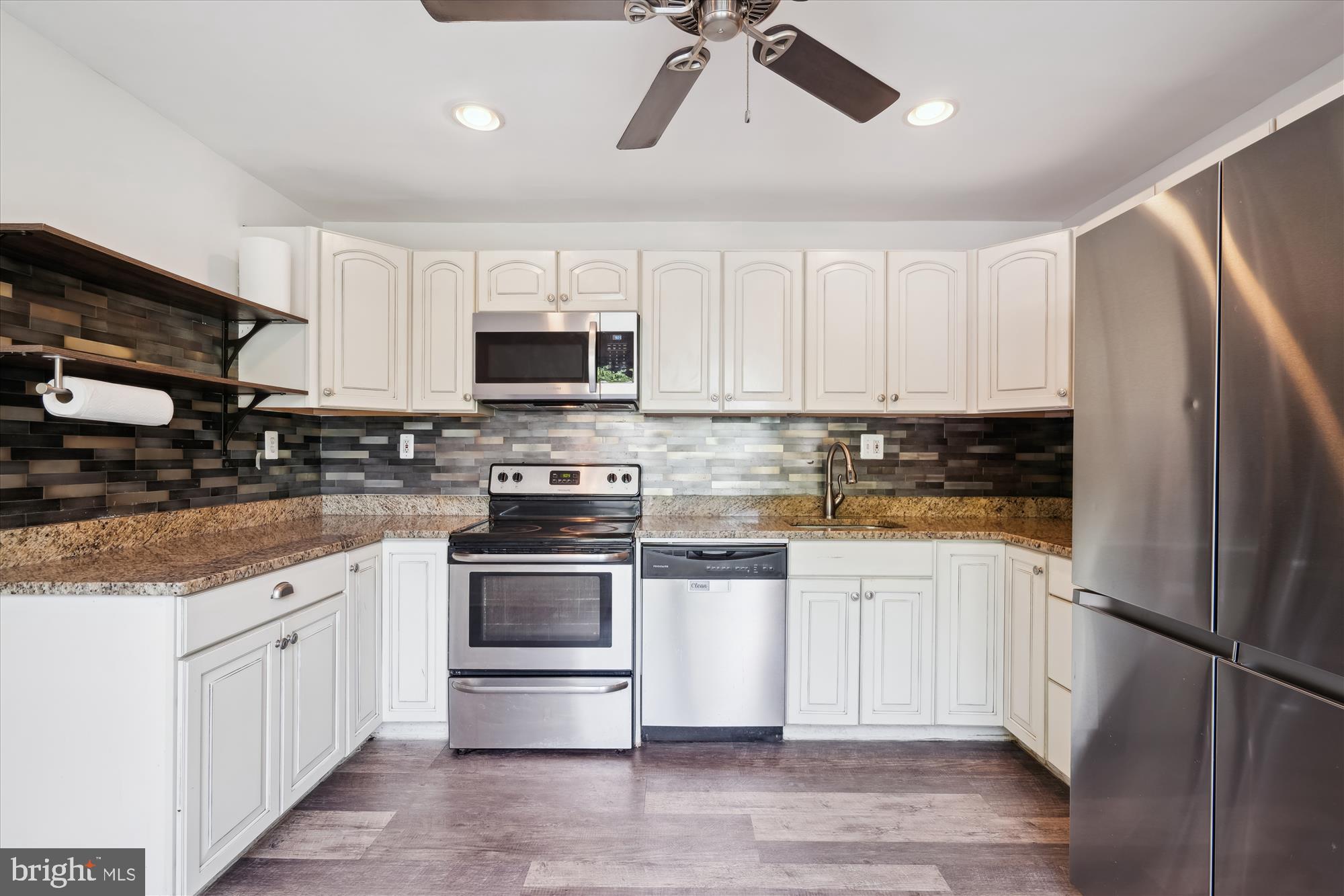 12812 Crisfield Road Silver Spring, MD 20906 - Photo 16 of 83 a kitchen with stainless steel appliances granite countertop a refrigerator a stove a sink and white cabinets