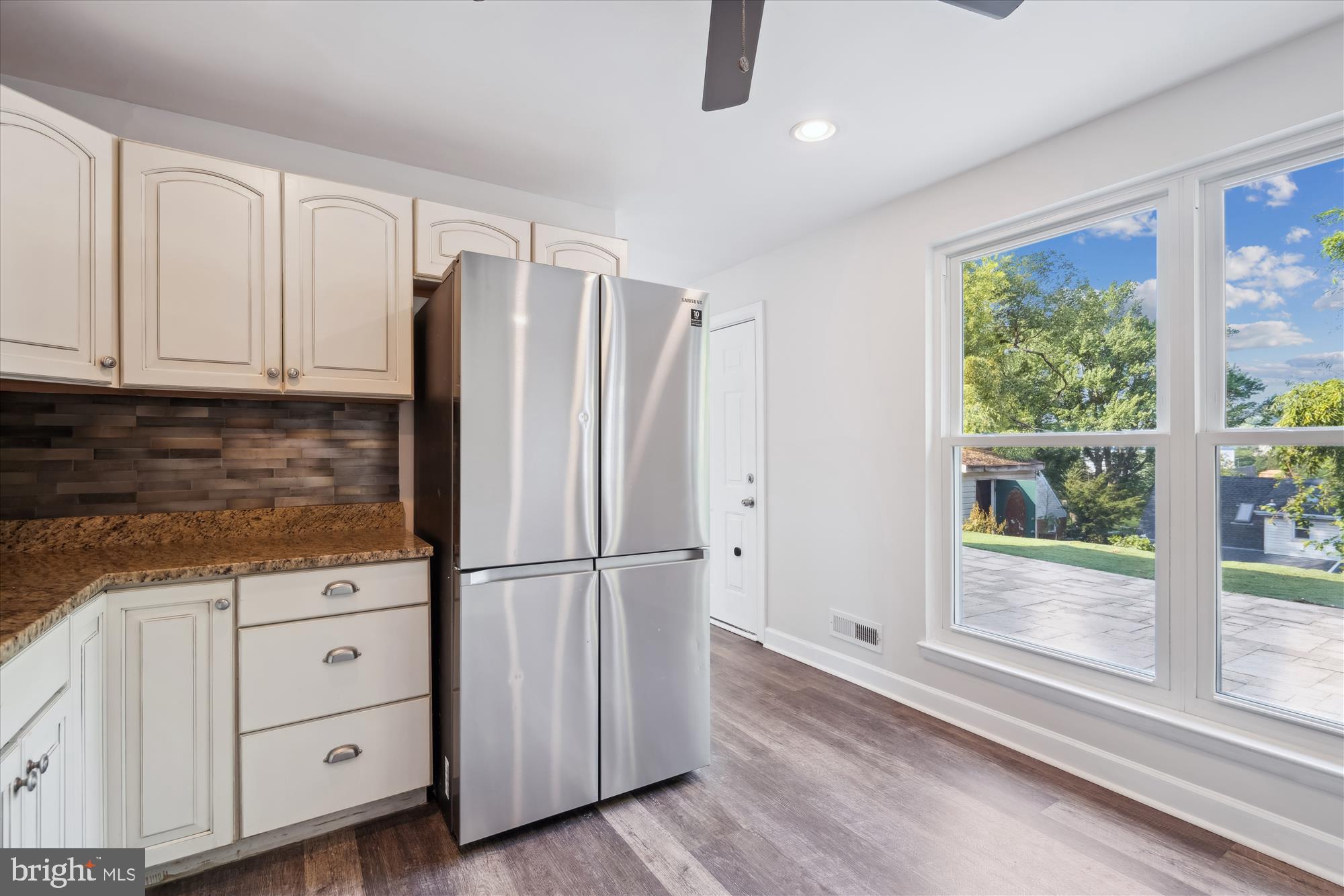 12812 Crisfield Road Silver Spring, MD 20906 - Photo 19 of 83 a kitchen with stainless steel appliances granite countertop a refrigerator and a window