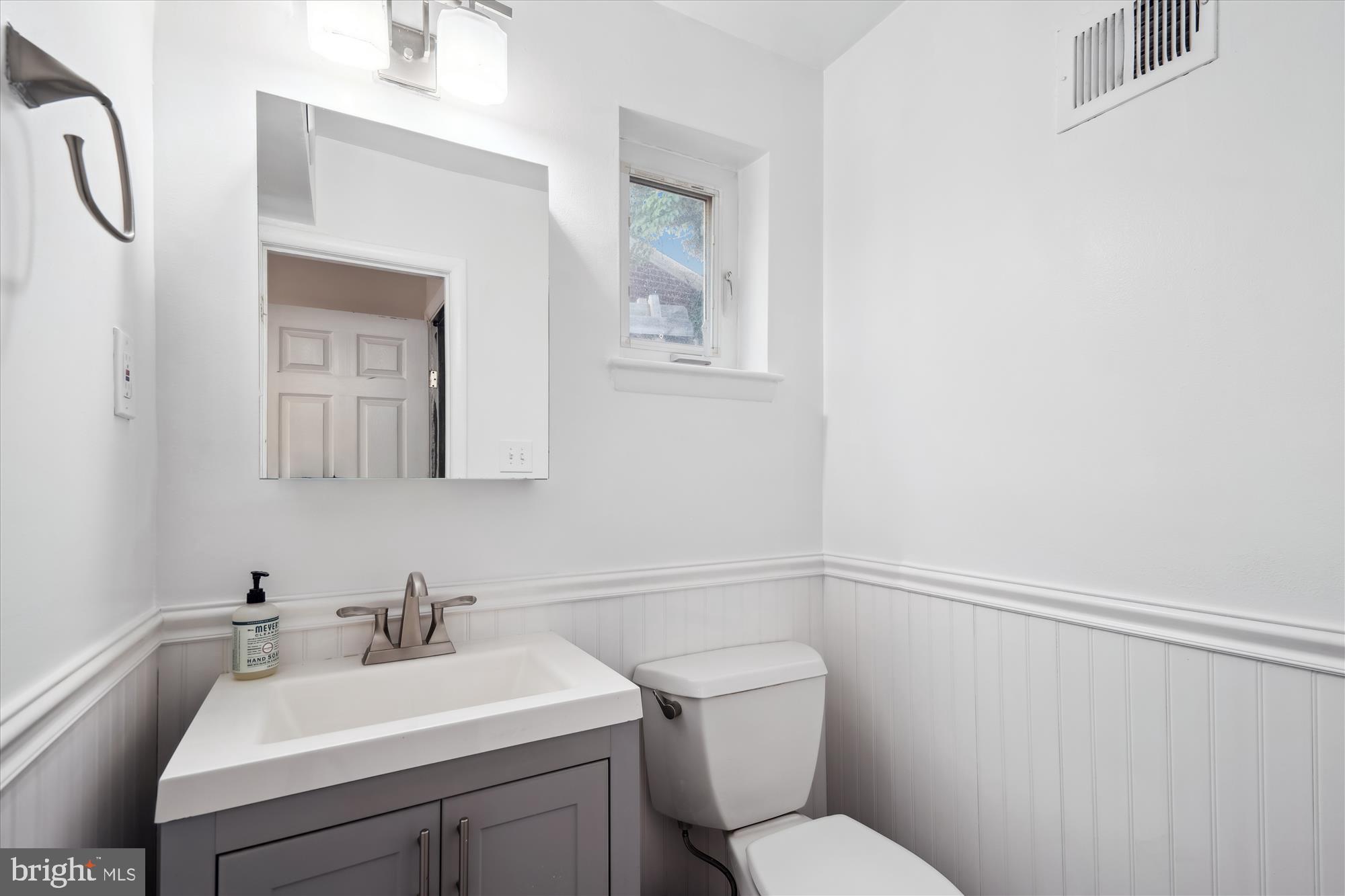 12812 Crisfield Road Silver Spring, MD 20906 - Photo 22 of 83 a bathroom with a toilet a sink and mirror