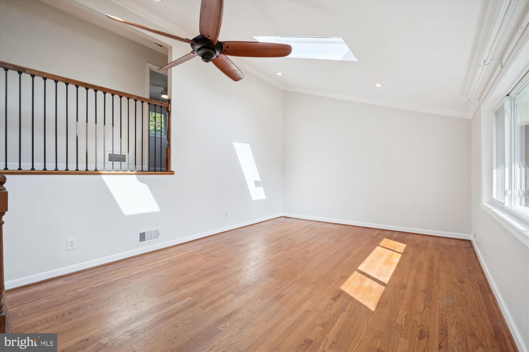 12812 Crisfield Road Silver Spring, MD 20906 - Photo 33 of 83 an empty room with wooden floor fan and windows