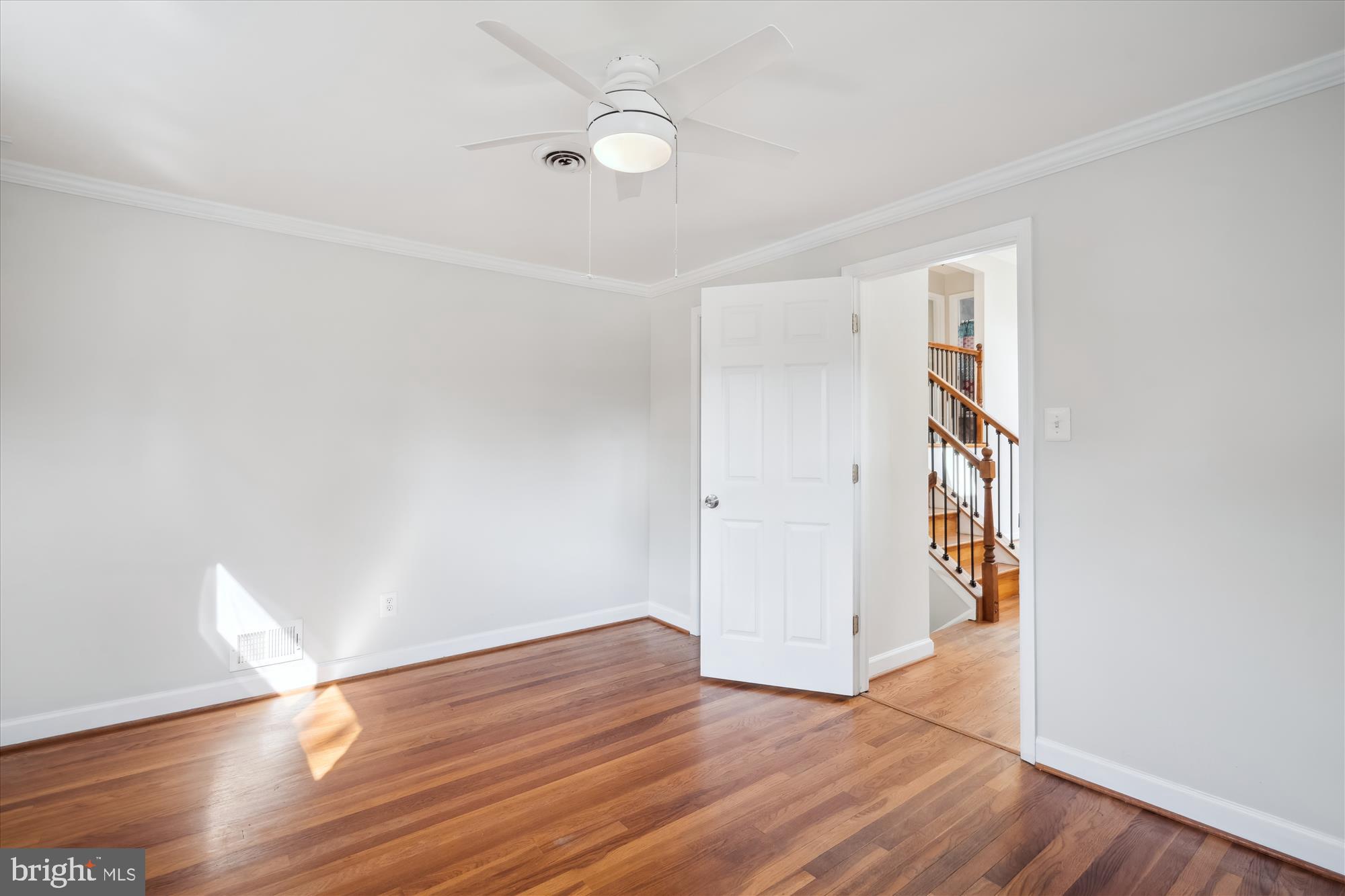 12812 Crisfield Road Silver Spring, MD 20906 - Photo 39 of 83 a view of an empty room with wooden floor and a window