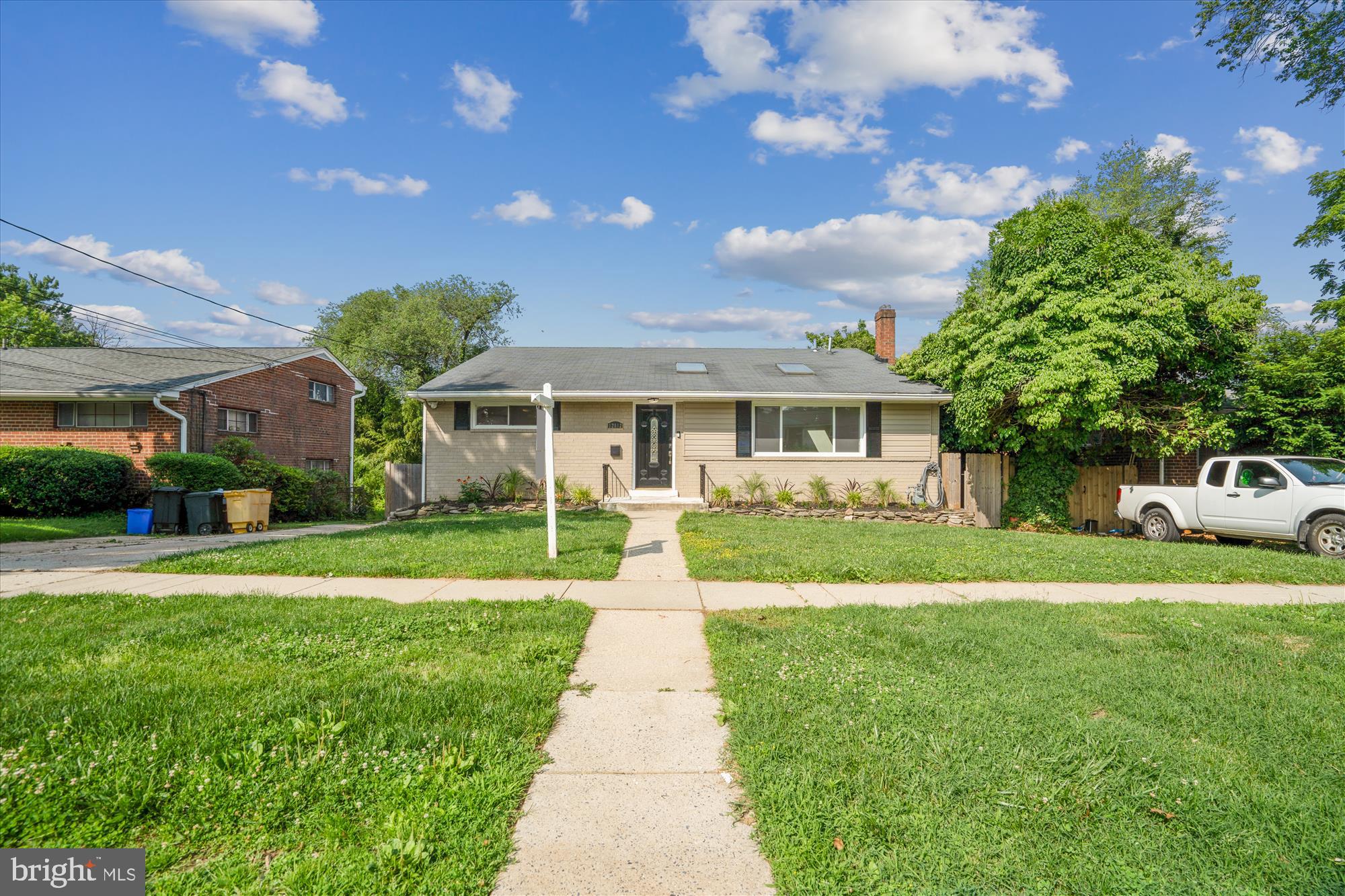 12812 Crisfield Road Silver Spring, MD 20906 - Photo 4 of 83 a front view of a house with a yard and garage