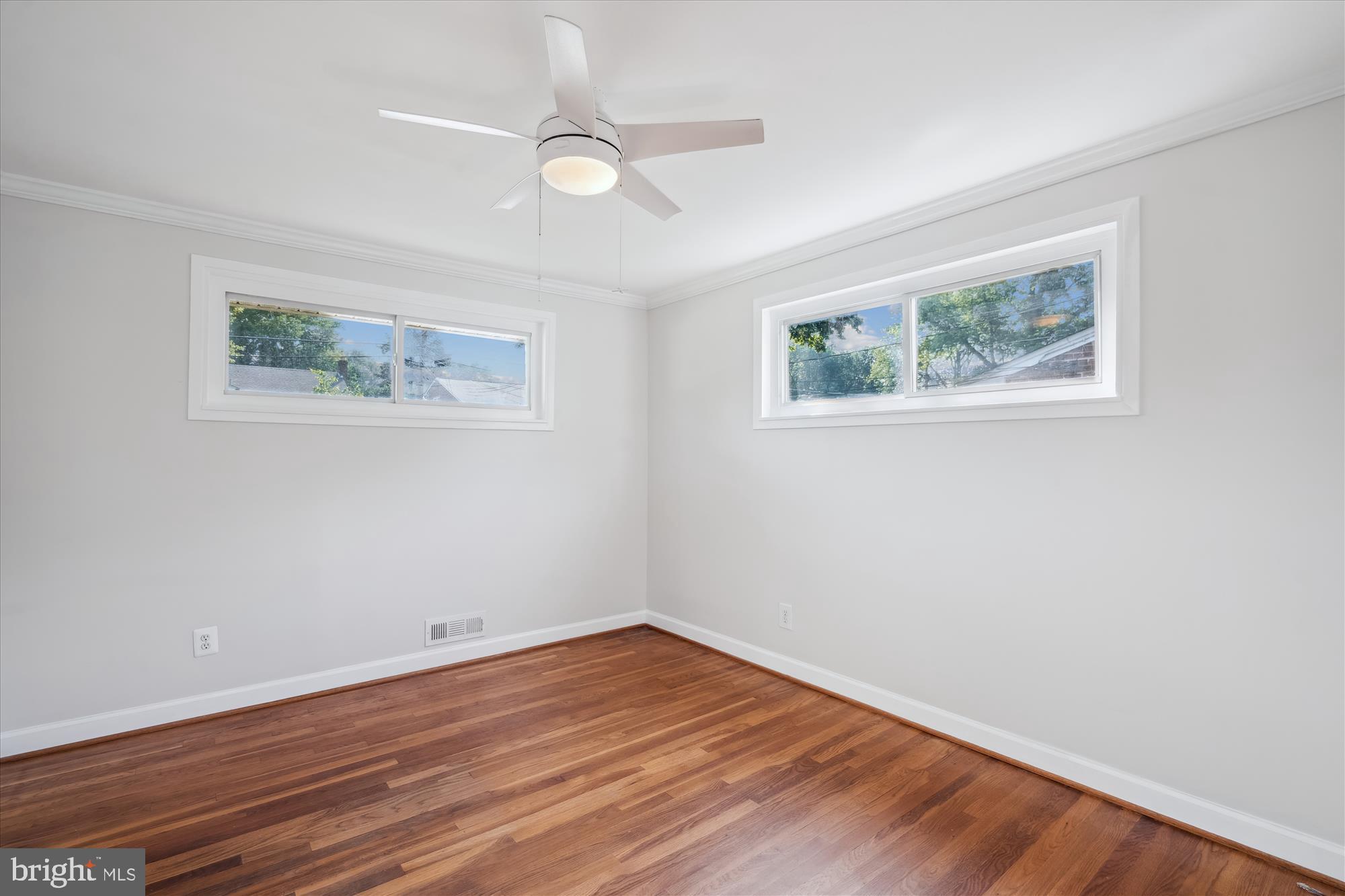 12812 Crisfield Road Silver Spring, MD 20906 - Photo 41 of 83 a view of an empty room with wooden floor and a window