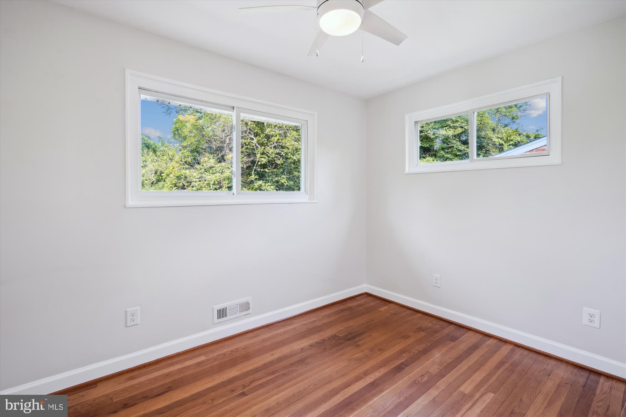 12812 Crisfield Road Silver Spring, MD 20906 - Photo 44 of 83 wooden floor in an empty room with a window
