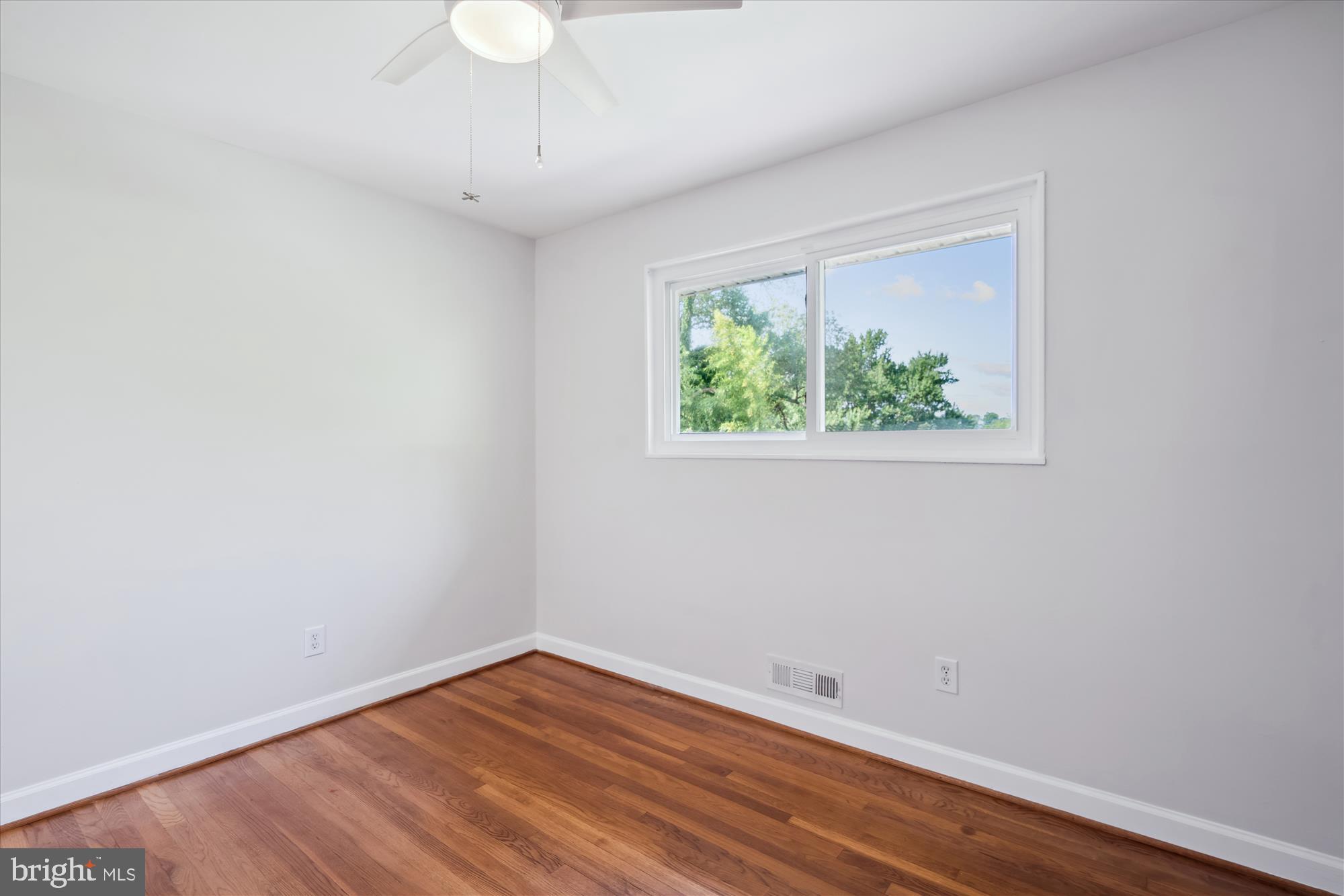 12812 Crisfield Road Silver Spring, MD 20906 - Photo 45 of 83 a view of an empty room with wooden floor and a window