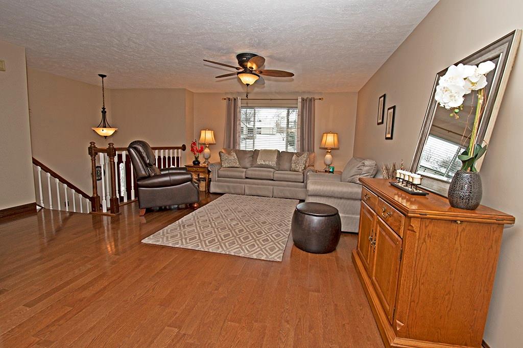 Spacious living room with hardwood floors and upgraded lighting