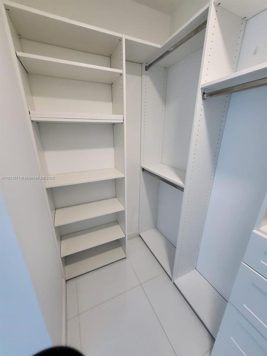 851 Northeast 1st Avenue, Unit 2008 Miami, FL 33132 - Photo 11 of 18 a view of walk in closet with empty racks