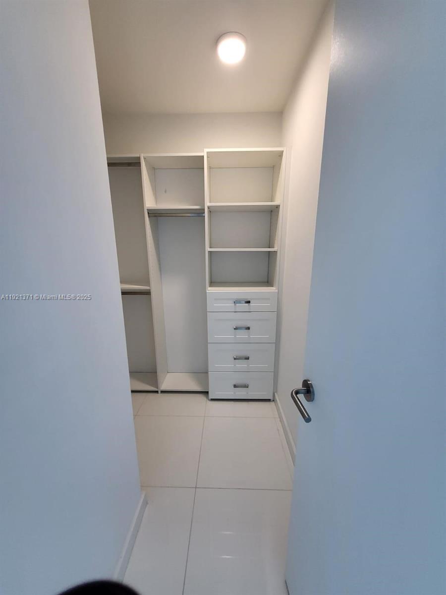 851 Northeast 1st Avenue, Unit 2008 Miami, FL 33132 - Photo 12 of 18 a view of an empty walk in closet