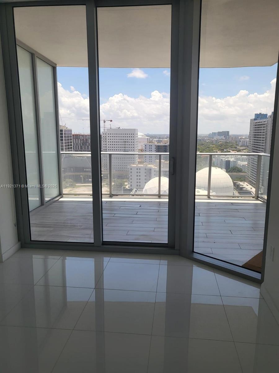 851 Northeast 1st Avenue, Unit 2008 Miami, FL 33132 - Photo 2 of 18 a view of a glass door with a from a window