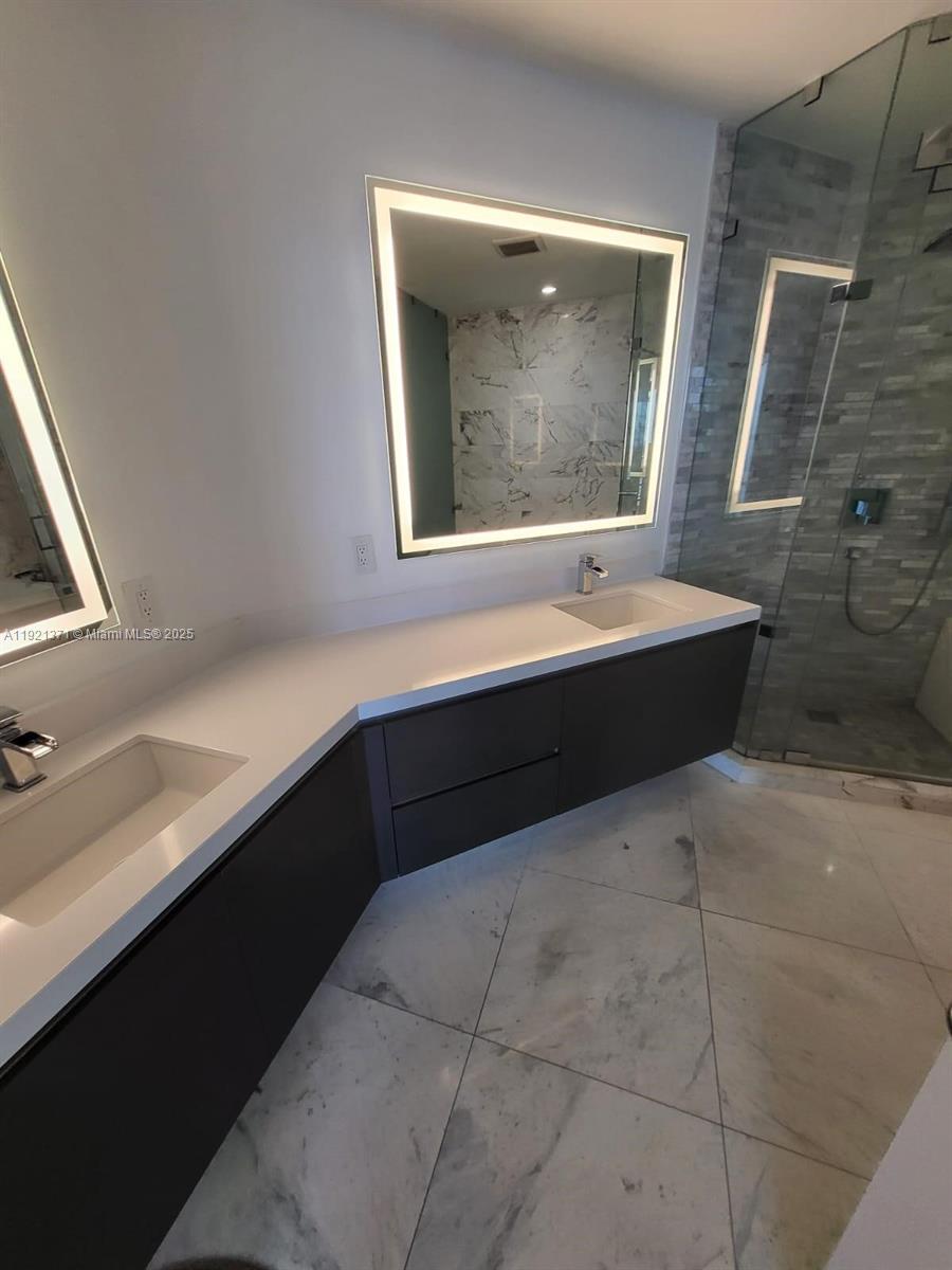 851 Northeast 1st Avenue, Unit 2008 Miami, FL 33132 - Photo 3 of 18 a bathroom with a sink and a bathtub