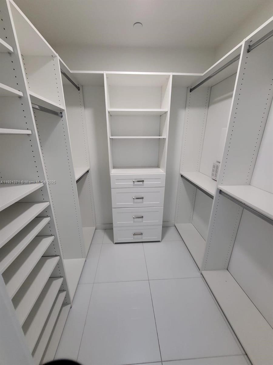 851 Northeast 1st Avenue, Unit 2008 Miami, FL 33132 - Photo 7 of 18 a view of walk in closet with empty racks