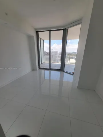 an empty room with large windows