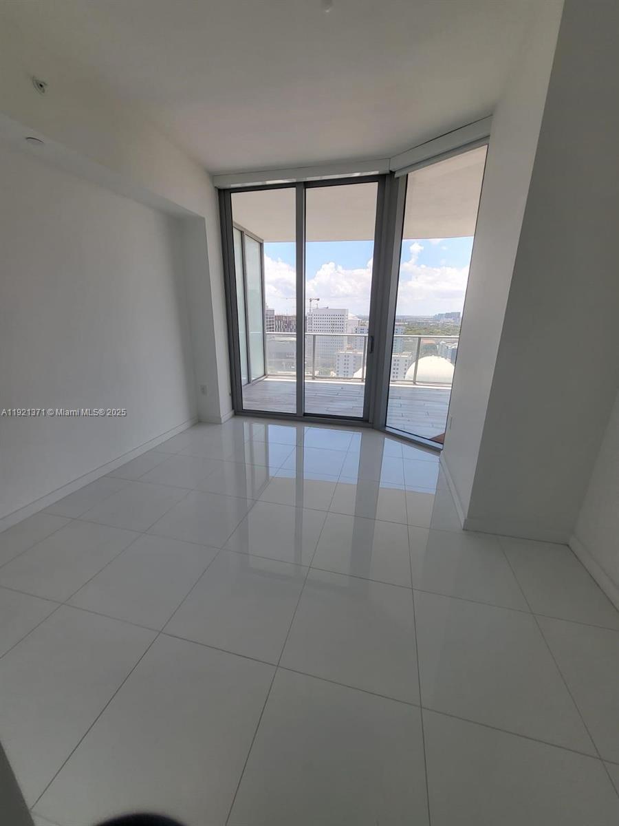 851 Northeast 1st Avenue, Unit 2008 Miami, FL 33132 - Photo 8 of 18 an empty room with large windows