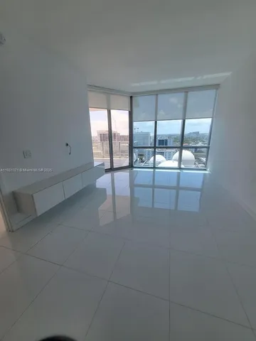 a view of a livingroom with an empty space and window