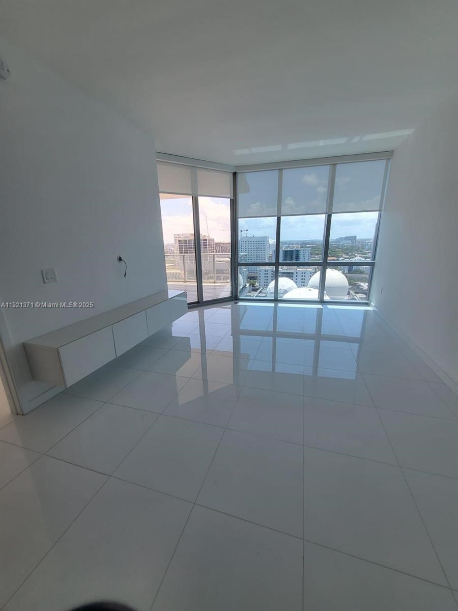 851 Northeast 1st Avenue, Unit 2008 Miami, FL 33132 - Photo 9 of 18 a view of a livingroom with an empty space and window