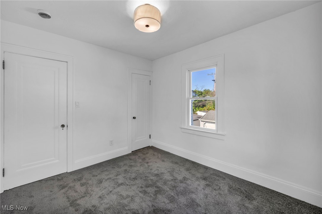 2128 Hampstead Road Cleveland Heights, OH 44118 - Photo 23 of 32 Unfurnished bedroom featuring dark carpet and baseboards
