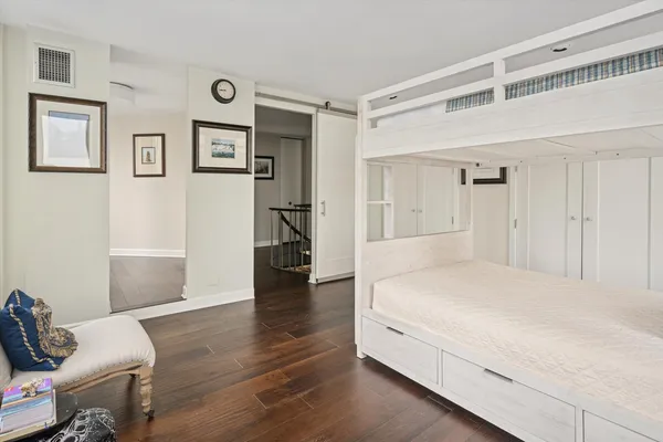 a spacious bedroom with a bed and a view of closet