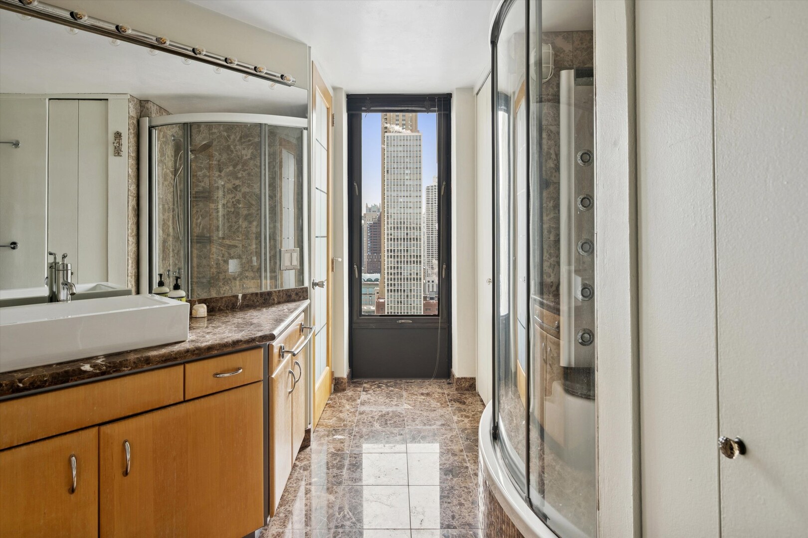 100 East Walton Street, Unit 41DE Chicago, IL 60611 - Photo 20 of 35 a bathroom with a granite countertop sink and a mirror