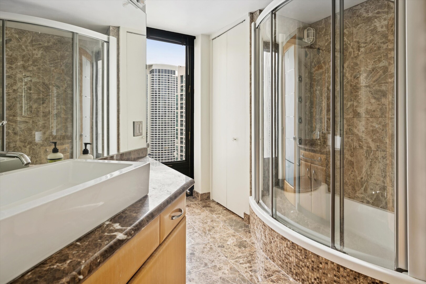 100 East Walton Street, Unit 41DE Chicago, IL 60611 - Photo 21 of 35 a spacious bathroom with a tub and shower