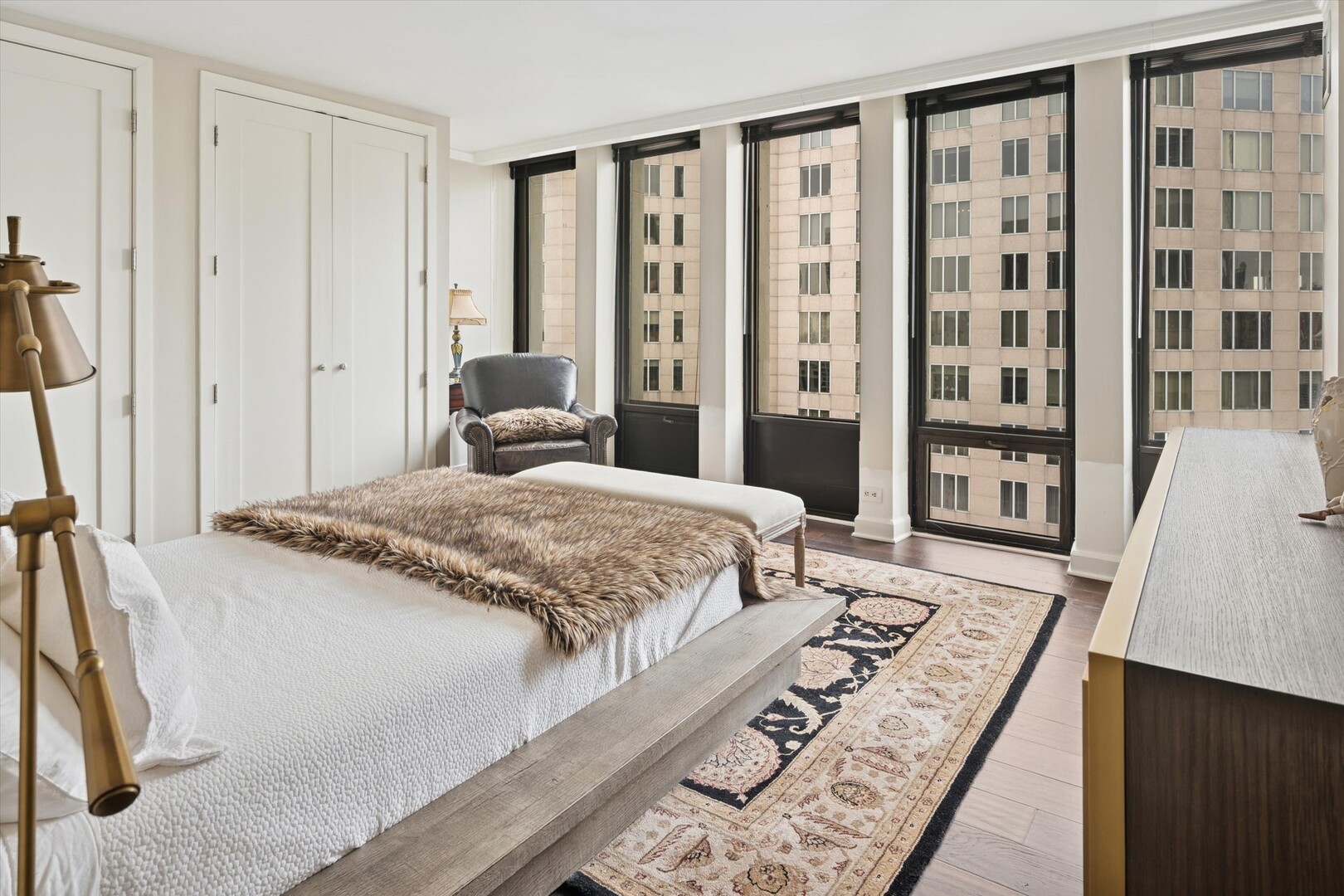 100 East Walton Street, Unit 41DE Chicago, IL 60611 - Photo 23 of 35 a bedroom with a large bed and a large window