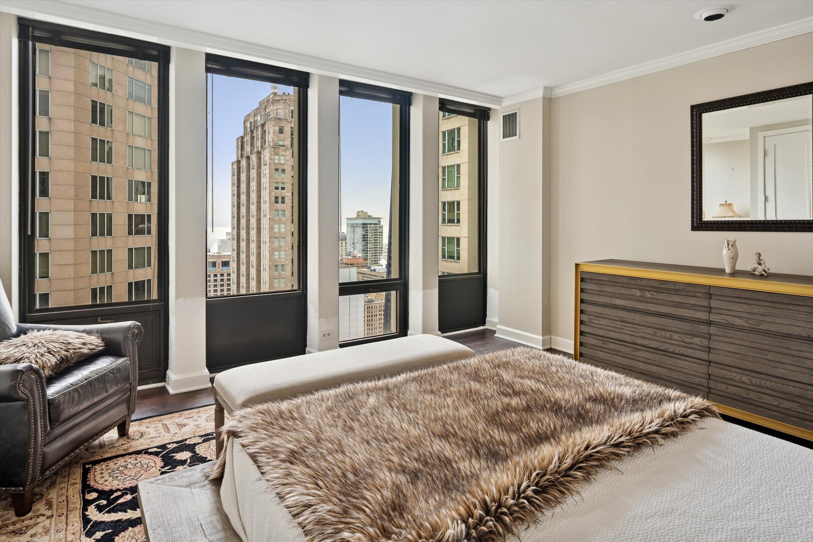 100 East Walton Street, Unit 41DE Chicago, IL 60611 - Photo 24 of 35 a bedroom with a bed and a dresser