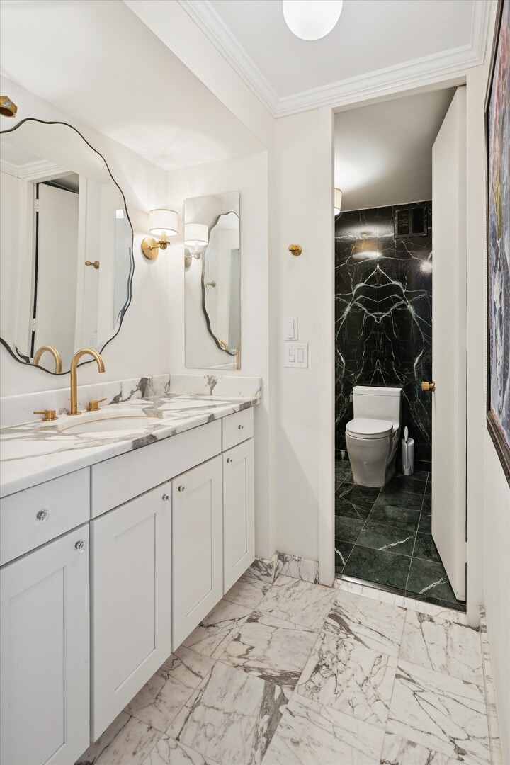 100 East Walton Street, Unit 41DE Chicago, IL 60611 - Photo 25 of 35 a bathroom with a sink and a mirror