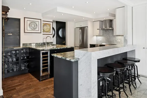 a kitchen with stainless steel appliances granite countertop a stove and a refrigerator