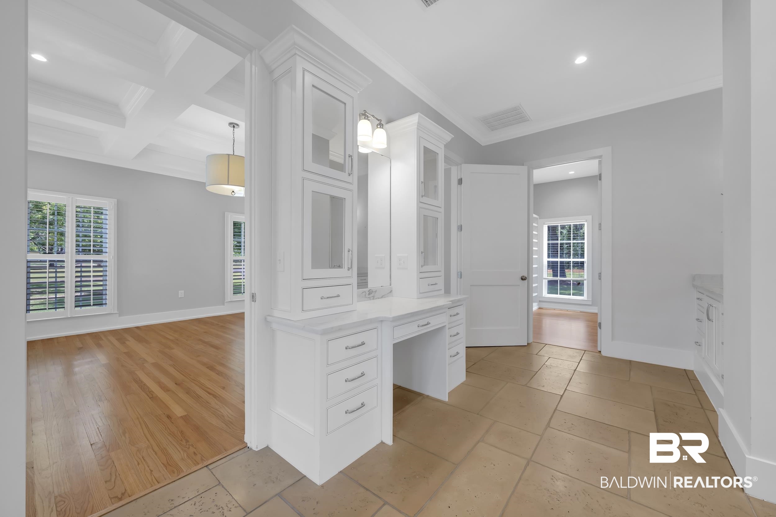 43199 Pine Grove Road Bay Minette, AL 36507 - Photo 47 of 71 Built-in vanity with white cabinetry, upper glass-front cabinets, and a decorative light fixture
