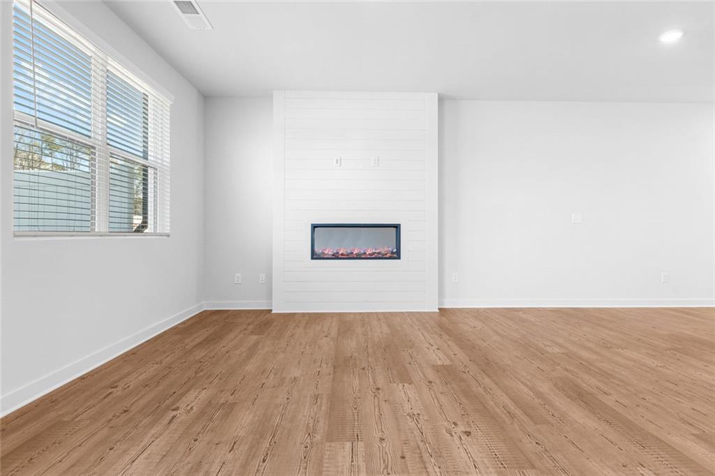 1925 Westwind Street Lawrenceville, GA 30043 - Photo 11 of 27 a view of an empty room with wooden floor and a window