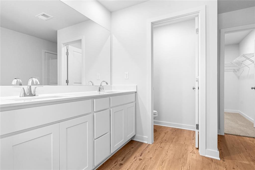 1925 Westwind Street Lawrenceville, GA 30043 - Photo 16 of 27 a bathroom with a double vanity sink and mirror