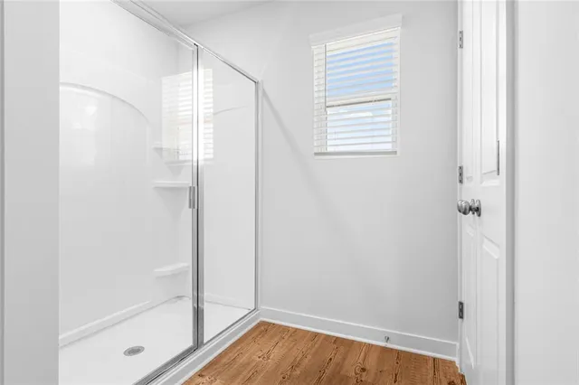 a bathroom with a bathtub and shower