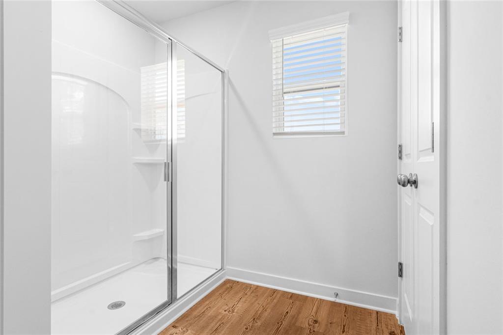 1925 Westwind Street Lawrenceville, GA 30043 - Photo 17 of 27 a bathroom with a bathtub and shower