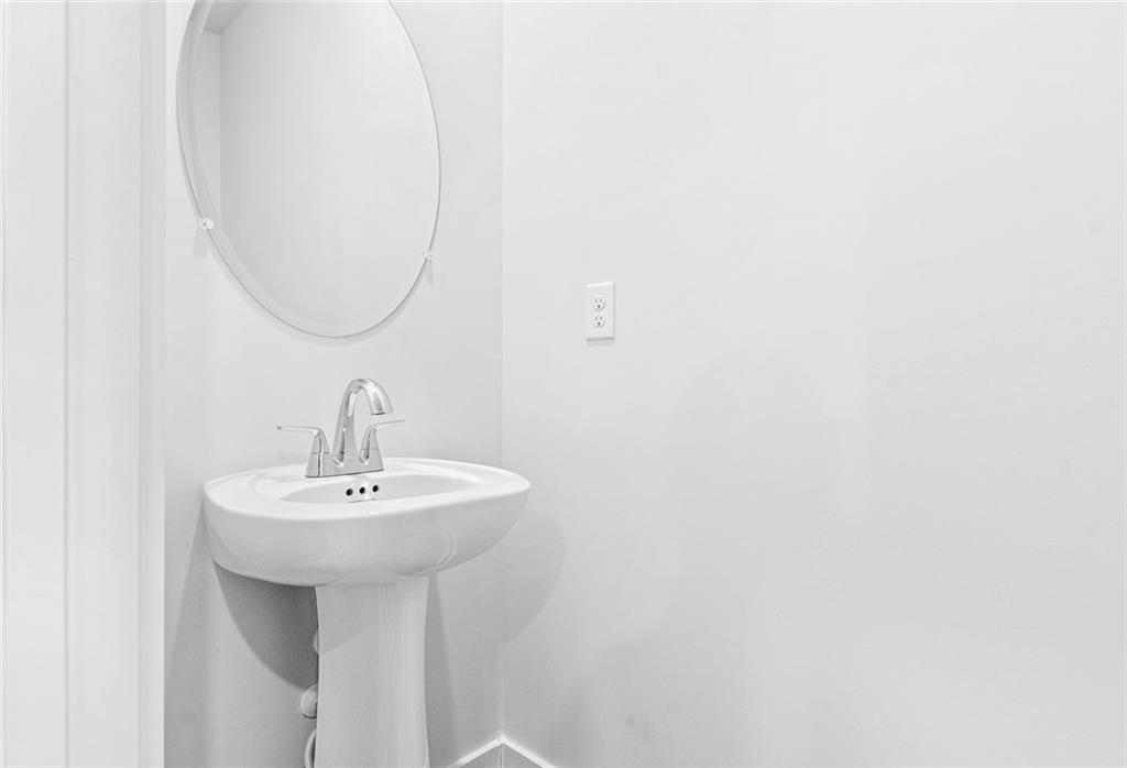 1925 Westwind Street Lawrenceville, GA 30043 - Photo 18 of 27 a bathroom with a sink and a mirror