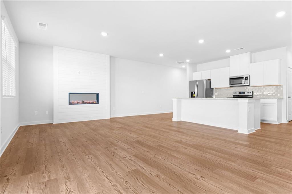 1925 Westwind Street Lawrenceville, GA 30043 - Photo 5 of 27 a view of kitchen with wooden floor and electronic appliances