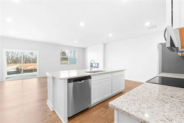 a kitchen with a sink stove and refrigerator