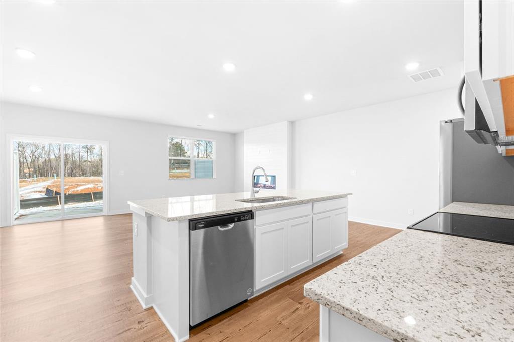 1925 Westwind Street Lawrenceville, GA 30043 - Photo 7 of 27 a kitchen with a sink stove and refrigerator
