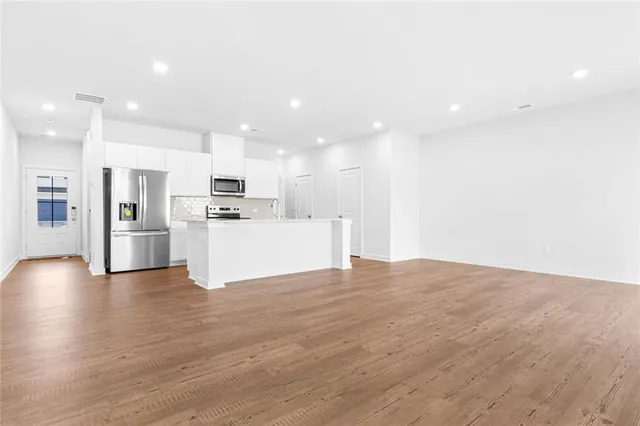 a view of a kitchen with a sink wooden floor and a kitchen