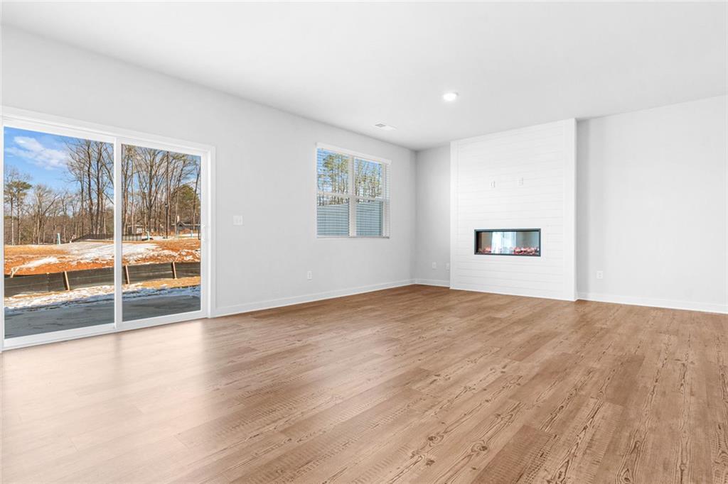 1925 Westwind Street Lawrenceville, GA 30043 - Photo 9 of 27 a view of empty room with wooden floor and fan