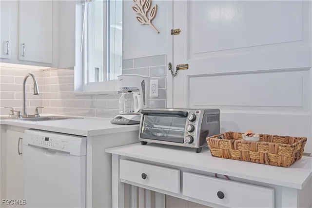 a kitchen with stainless steel appliances granite countertop a sink and cabinets