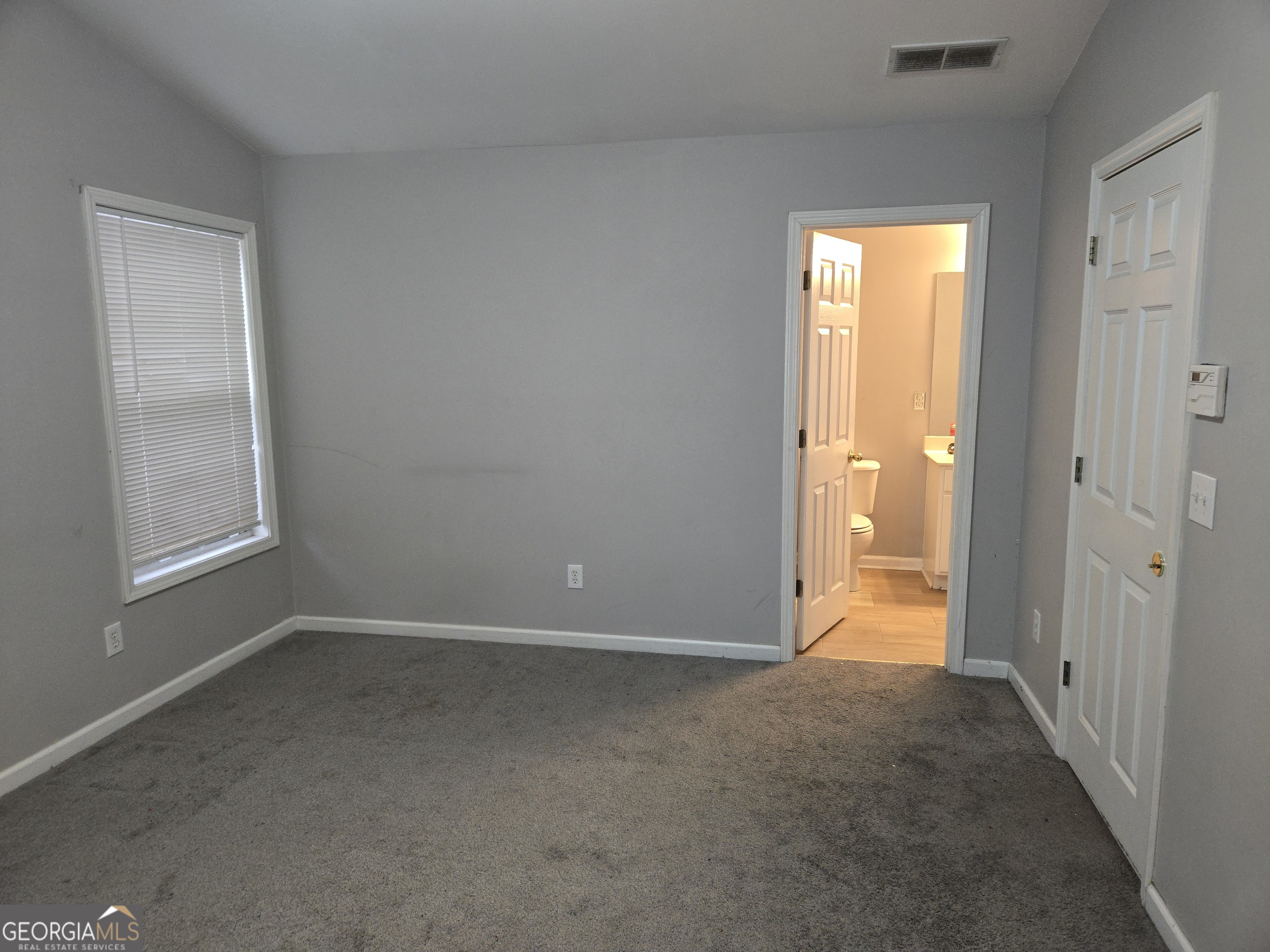1558 Silver Ridge Drive Southwest Austell, GA 30106 - Photo 15 of 18 a view of an empty room with closet and a window