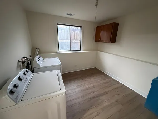 a view of storage and utility room with a window