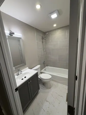 a bathroom with a toilet a sink and bathtub