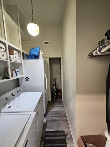 a view of a hallway to a livingroom with furniture